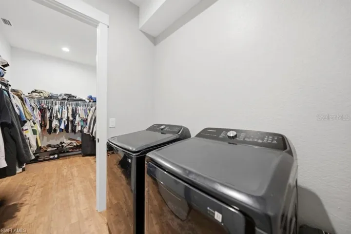 Dedicated laundry area featuring modern appliances and a neutral color palette
