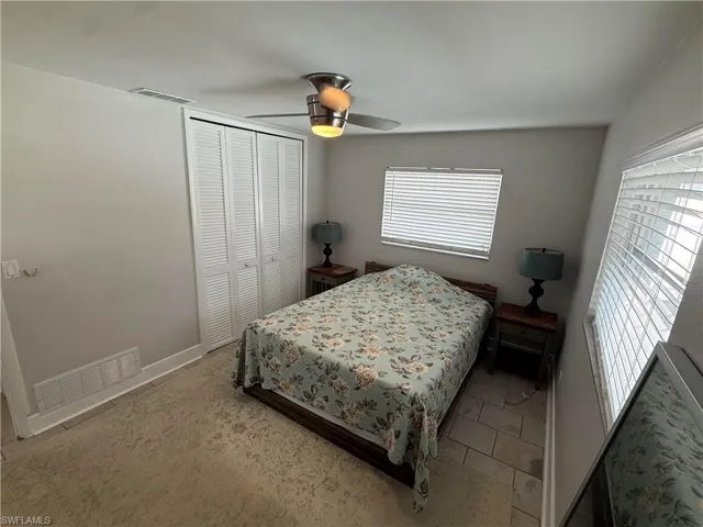 Recessed lighting, ceiling fan, louvered bi-fold closet doors, tile flooring, and multiple windows