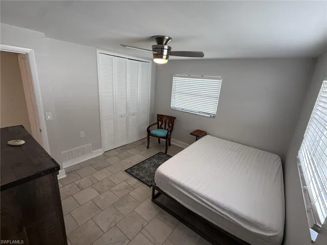 Recessed lighting, tile flooring, window with blinds, bi-fold closet doors, and a ceiling fan