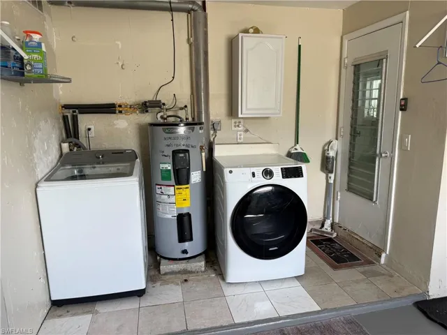 Tile flooring throughout this utility space with a built-in shelf and cabinetry for storage