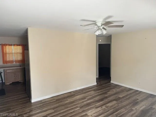 Full bathroom featuring a textured wall, a shower stall, wood finished floors, and vanity