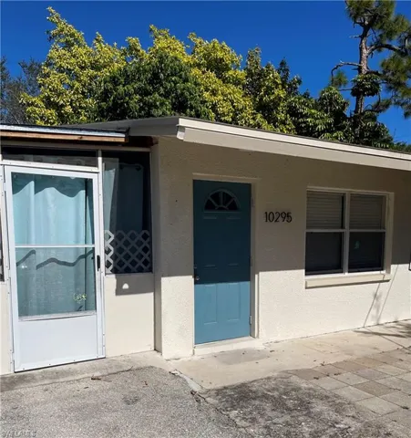Doorway to property with stucco siding