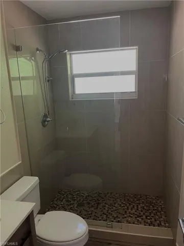 Bathroom featuring vanity and a stall shower