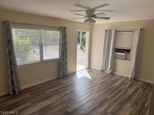Kitchen featuring open shelves, gray cabinets, appliances with stainless steel finishes, light countertops, and dark wood-style floors