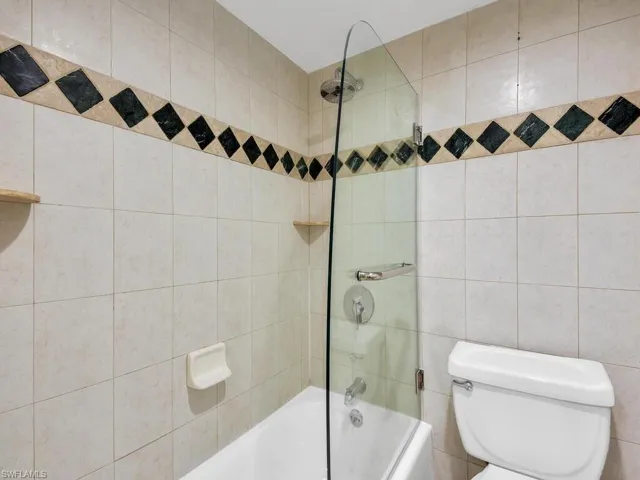 Full bath featuring shower / bath combination and toilet