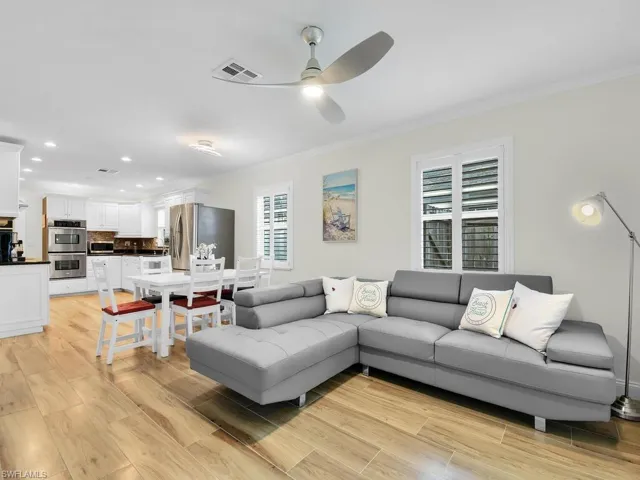 Living area featuring light wood finished floors, recessed lighting, crown molding, and ceiling fan