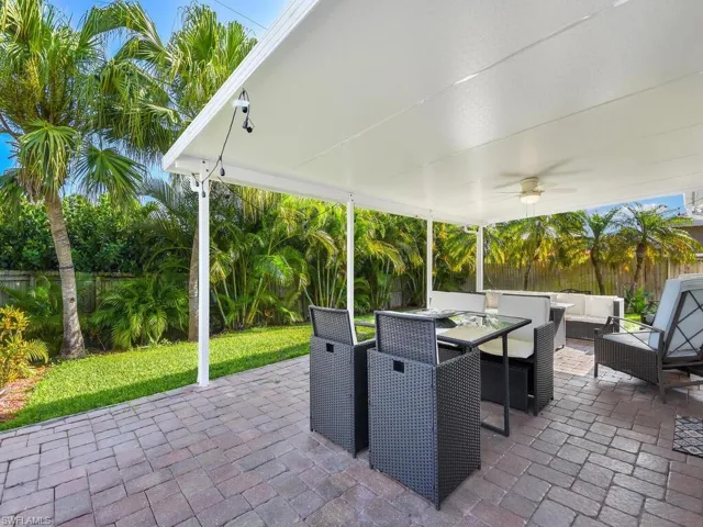 Fenced backyard featuring a ceiling fan, an outdoor living space, outdoor dining area, and a patio area