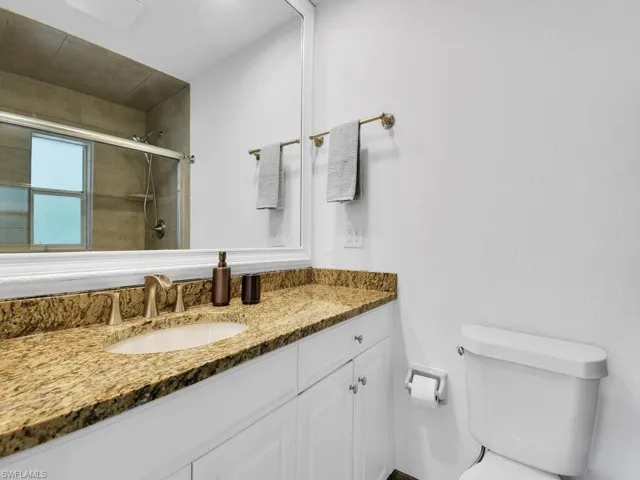 Full bath featuring vanity and a tile shower