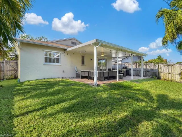 Rear view of property featuring a fenced backyard, ceiling fan, a patio, and stucco siding