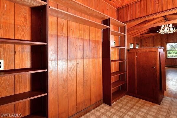Custom built in shelving with swinging doors to great room
