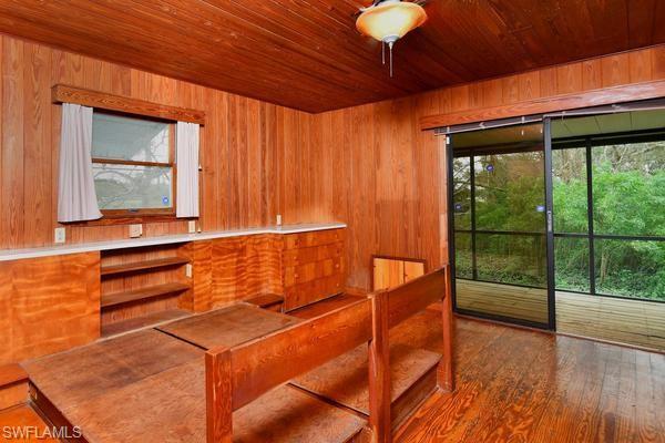 Master bedroom with sliding doors to enclosed screen porch .