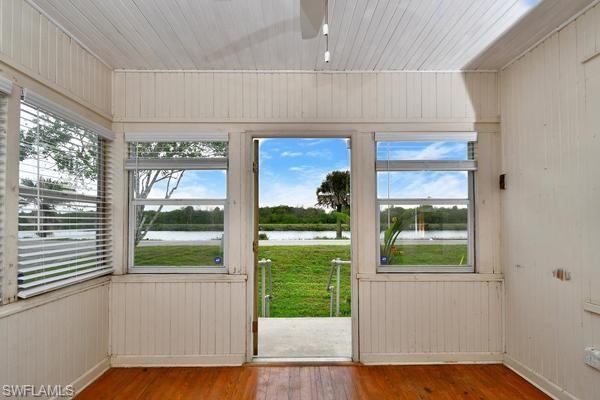 Entry, office or bonus room with waterfront  view
