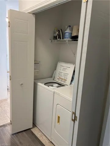 Laundry area featuring light wood-style floors and independent washer and dryer