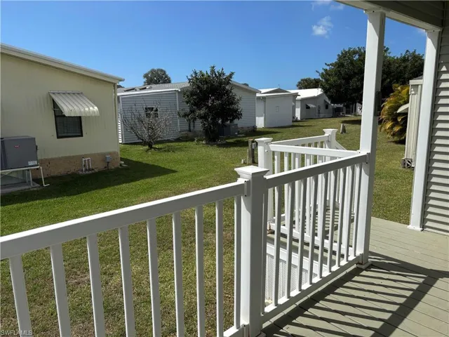 Wooden deck featuring a lawn
