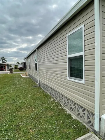 View of side of home with a yard