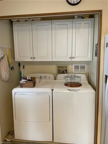 Laundry area featuring cabinets and washer and dryer