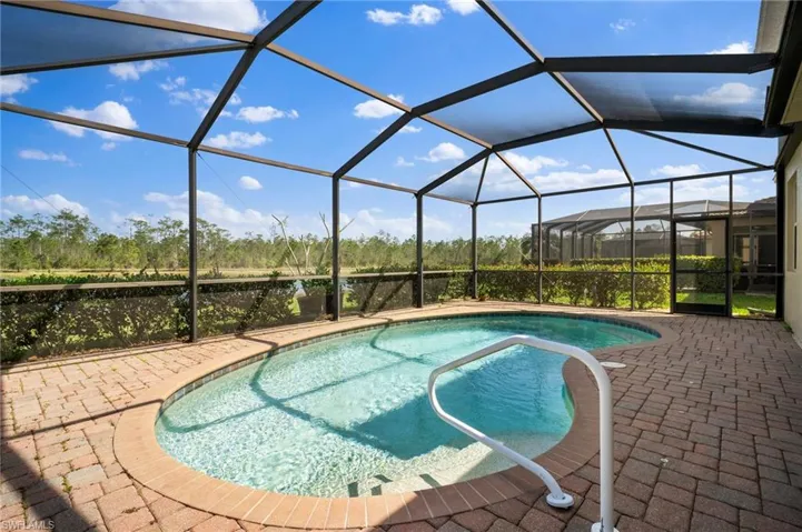 Pool with a lanai and a patio