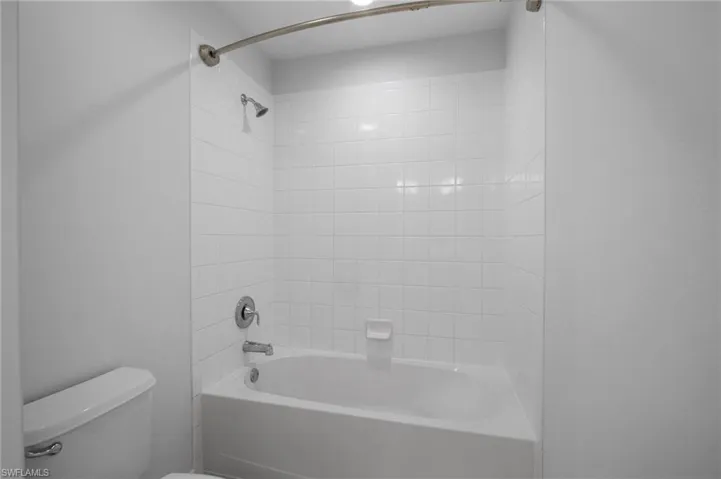 Bathroom with bathing tub / shower combination and toilet