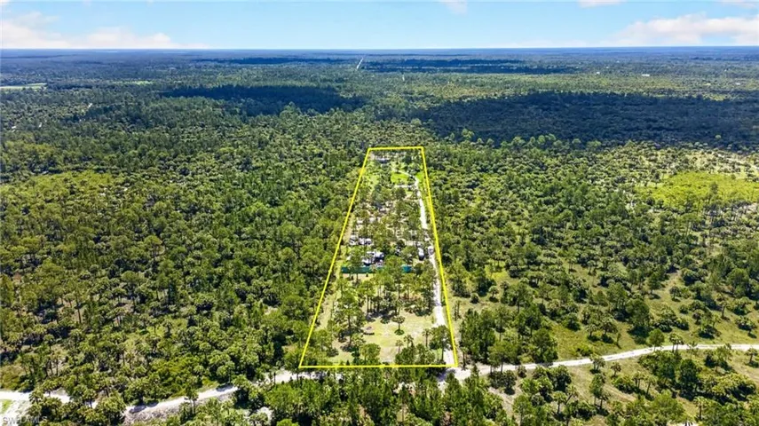Expansive parcel of land bordered by mature trees and natural vegetation
