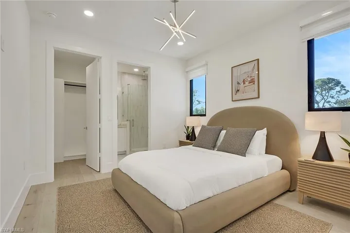 Bedroom with light wood-style flooring and hanging lights