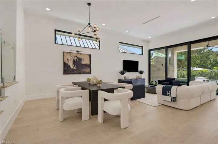 Dining room featuring light wood-style floors and suspended lighting