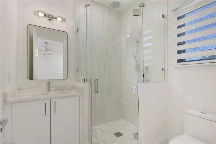 Full bathroom featuring vanity and a stall shower