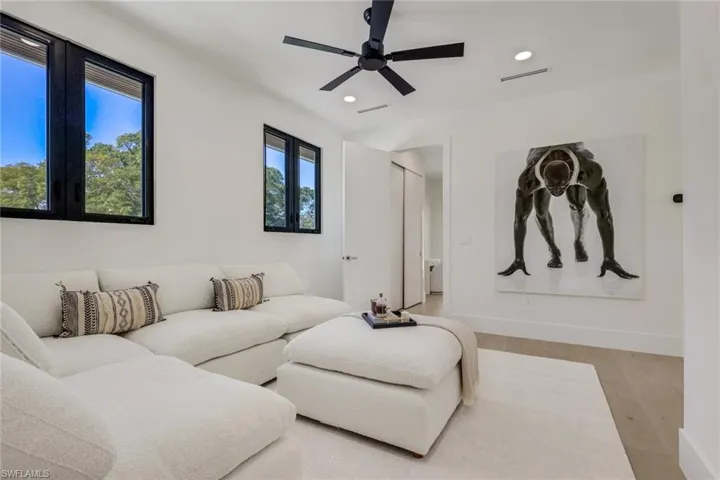 Living room featuring wood finished floors, a ceiling fan, and recessed lighting