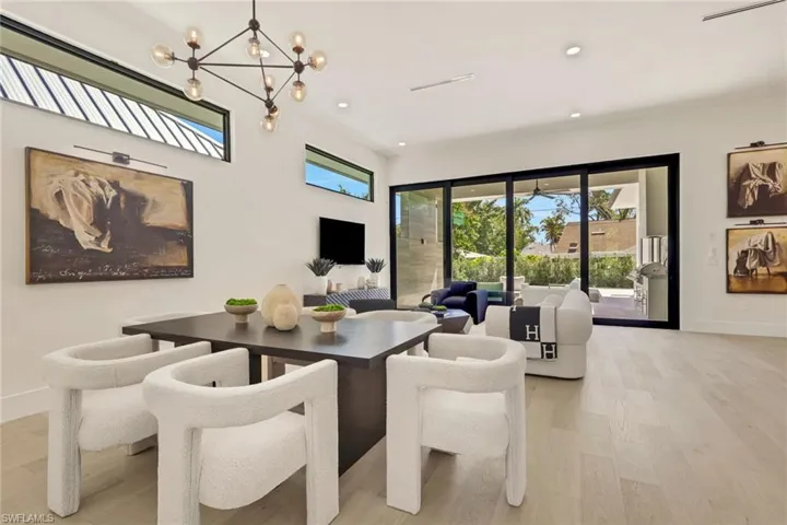 Dining space with light wood finished floors and a chandelier