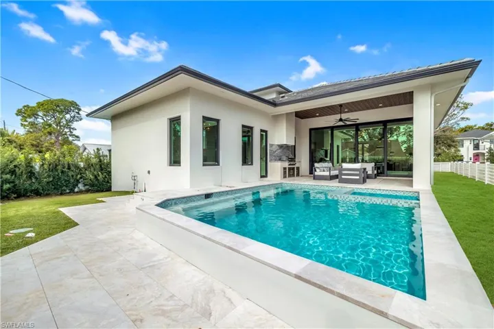 Rear view of property featuring a ceiling fan, an outdoor hangout area, a patio, and stucco siding