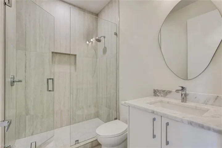 Bathroom featuring vanity and a stall shower
