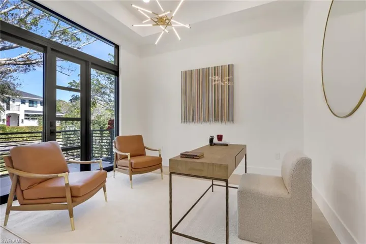 Home office featuring hanging lights and baseboards