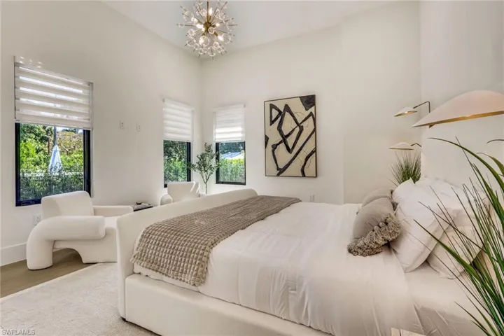 Bedroom featuring a chandelier and wood finished floors