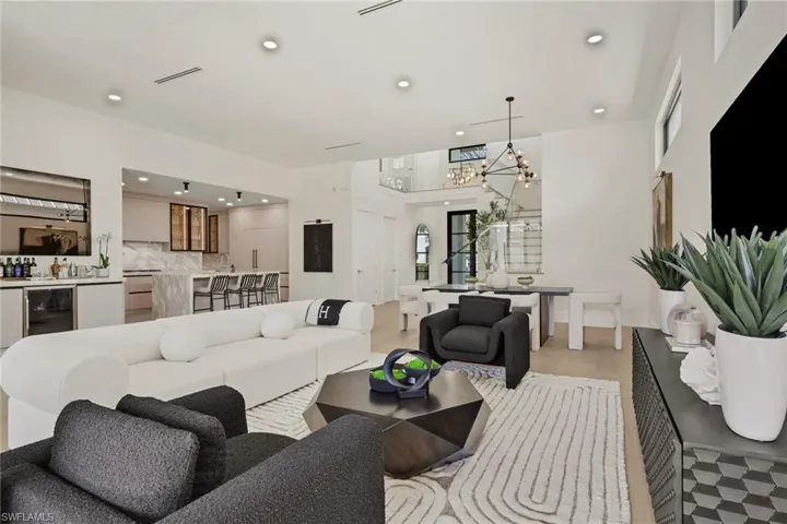 Living room featuring beverage cooler and a chandelier