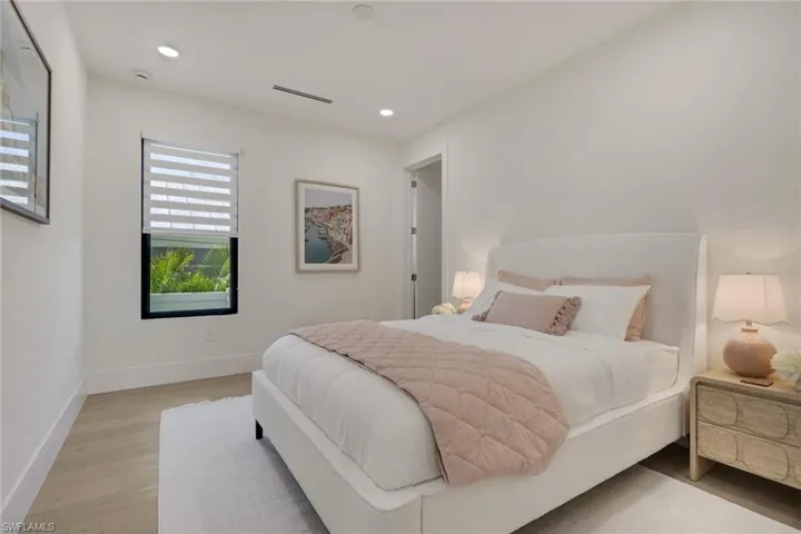 Bedroom with light wood finished floors and recessed lighting