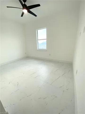 Empty room featuring ceiling fan