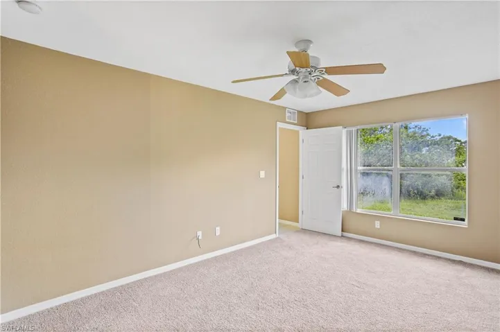 Spare room with ceiling fan and carpet floors