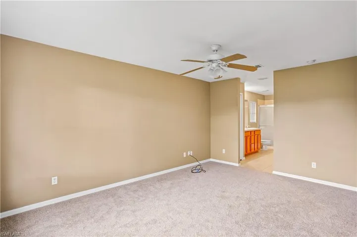 Unfurnished room with light carpet and ceiling fan