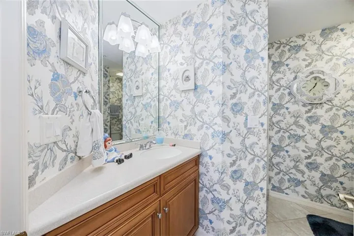 Bathroom with tile patterned floors and vanity
