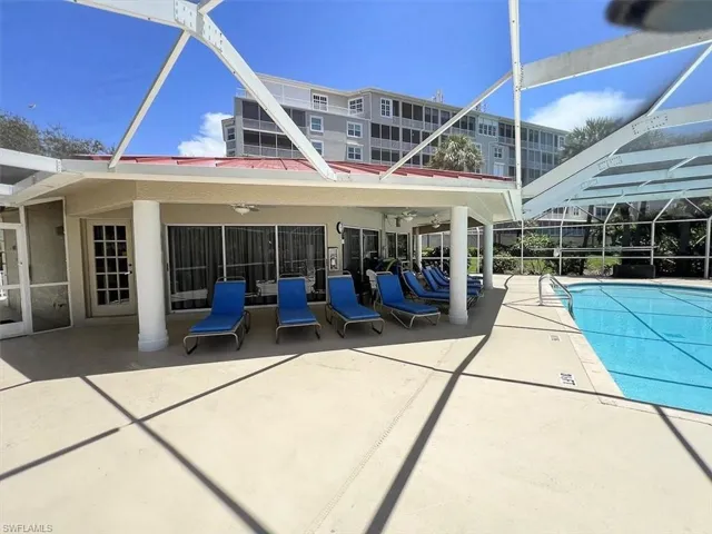 View of pool featuring ceiling fan, a patio area, and a lanai