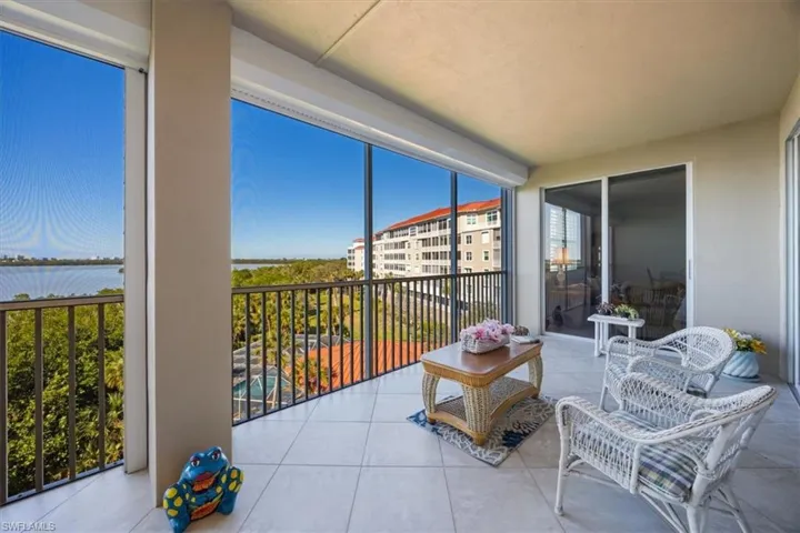 Sunroom featuring a wealth of natural light and a water view