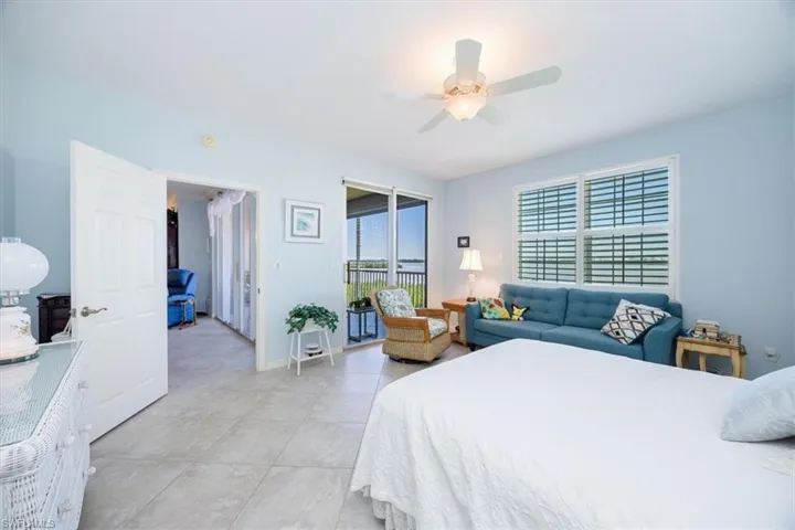 Bedroom featuring light tile patterned floors, access to outside, and ceiling fan