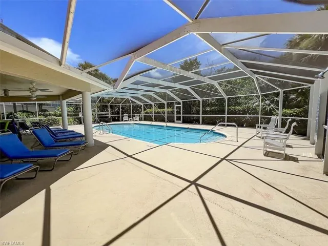 View of pool with ceiling fan, a lanai, and a patio