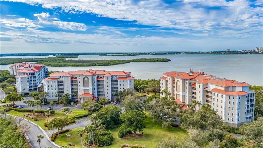 Birds eye view of property with a water view