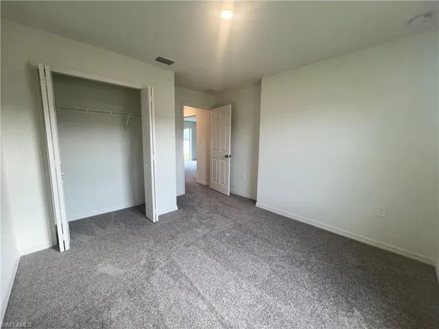 Unfurnished bedroom with carpet floors and a closet