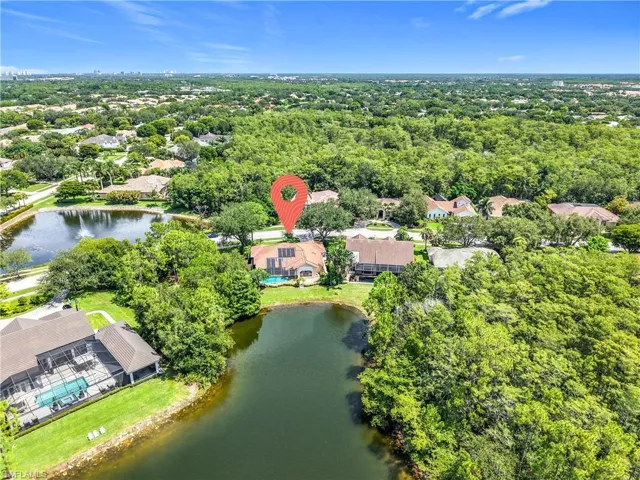 Aerial view of residential area featuring a large body of water