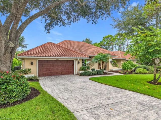 Mediterranean / spanish home featuring stucco siding, an attached garage, a front yard, decorative driveway, and a tiled roof