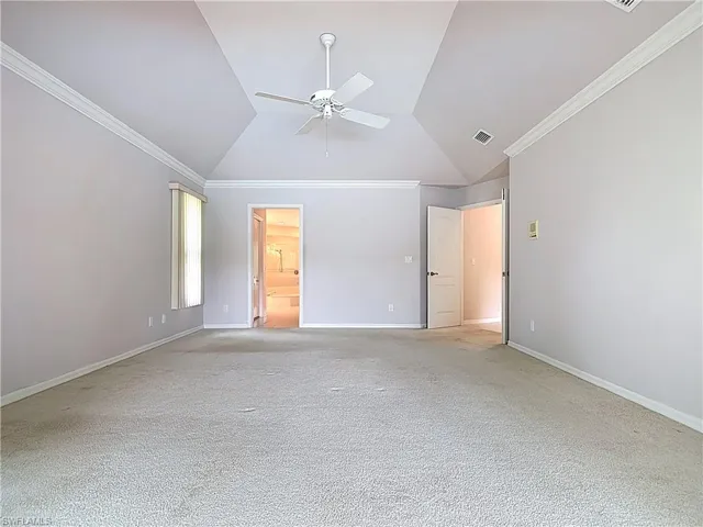 Master bedroom featuring French doors, vaulted ceiling, crown molding, facing towards the Master bathroom.