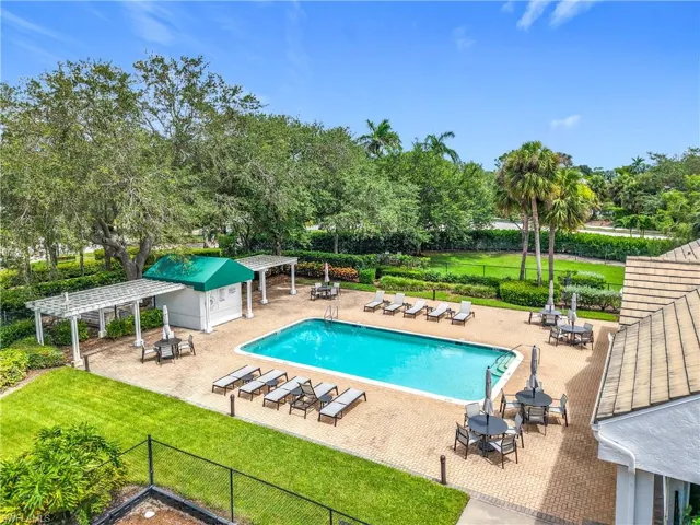 Community pool featuring a patio and outdoor dining area