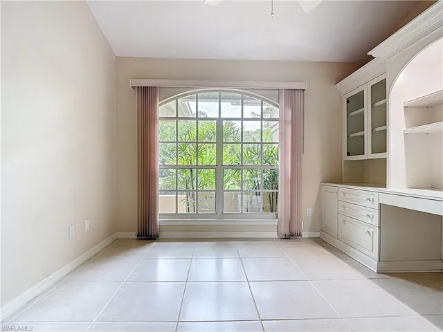 Den with French doors, a large desk, and a closet