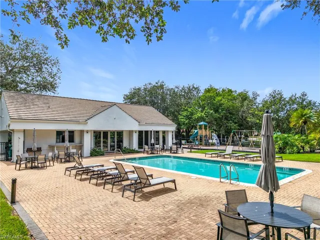 Community pool featuring a patio and outdoor dining area